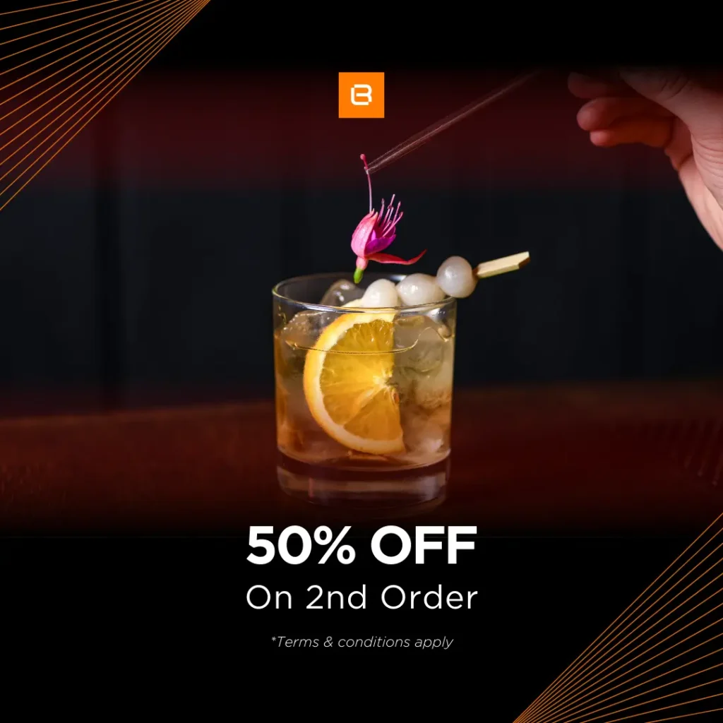 Promotional drink offer featuring a cocktail with an orange slice and flower garnish, advertising 50% off on a second order.
